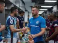 Giocatori di calcio si scambiano bevande energetiche, un ottimo modo per capire cosa bere prima di una partita di calcio.