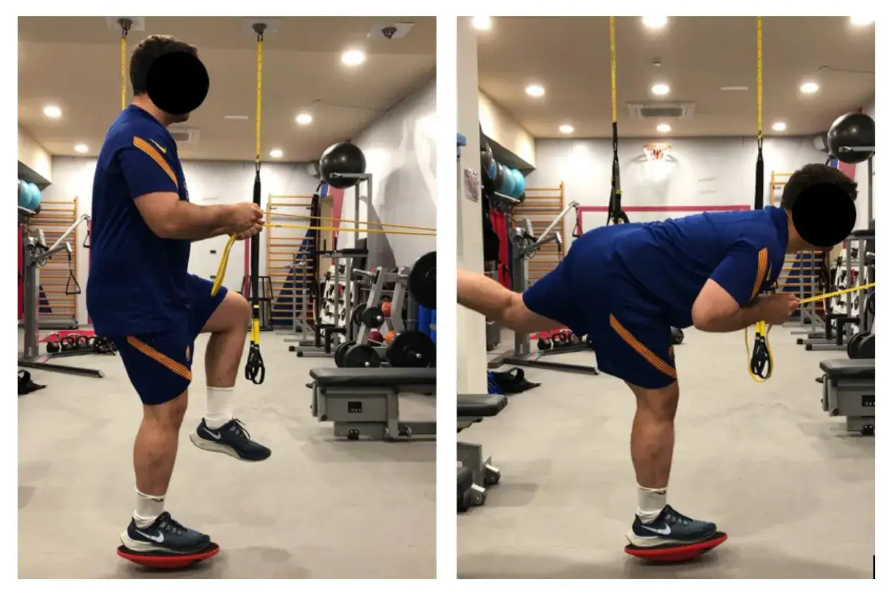 Uomo esegue esercizi di riscaldamento caviglie su una pedana instabile, usando elastici per resistenza.