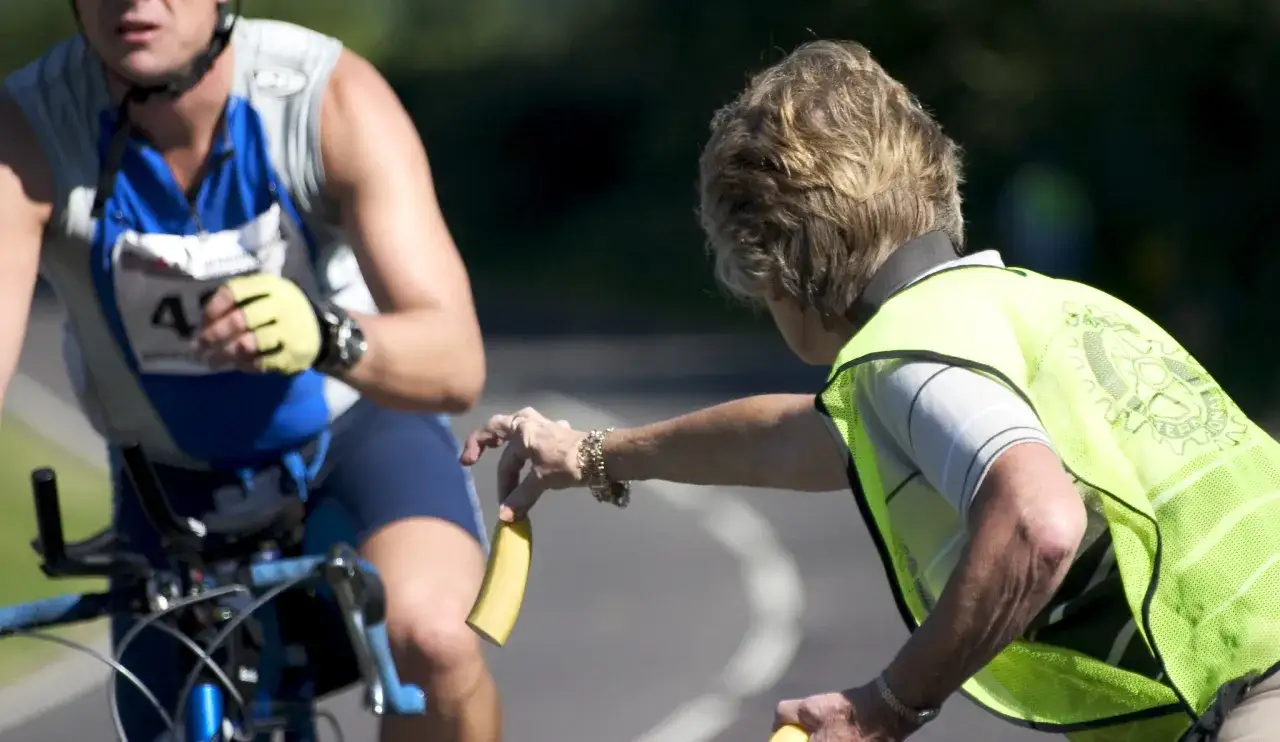 Atleta riceve una banana, ottima fonte di potassio, durante una gara.
